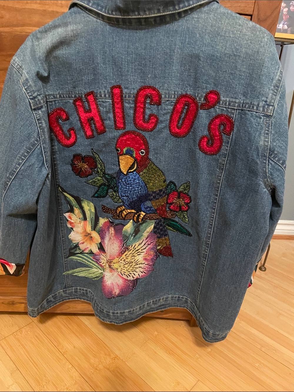 Chico's Blue Denim Jacket with Red Lettering and Multicolor Parrot Embroidery